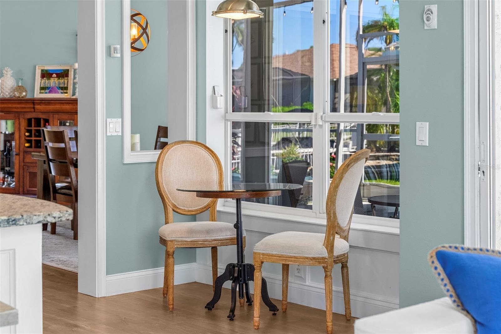 A sunny nook overlooking the lanai makes a charming spot for morning coffee or a quiet meal. - 4739 COMPASS DR, BRADENTON