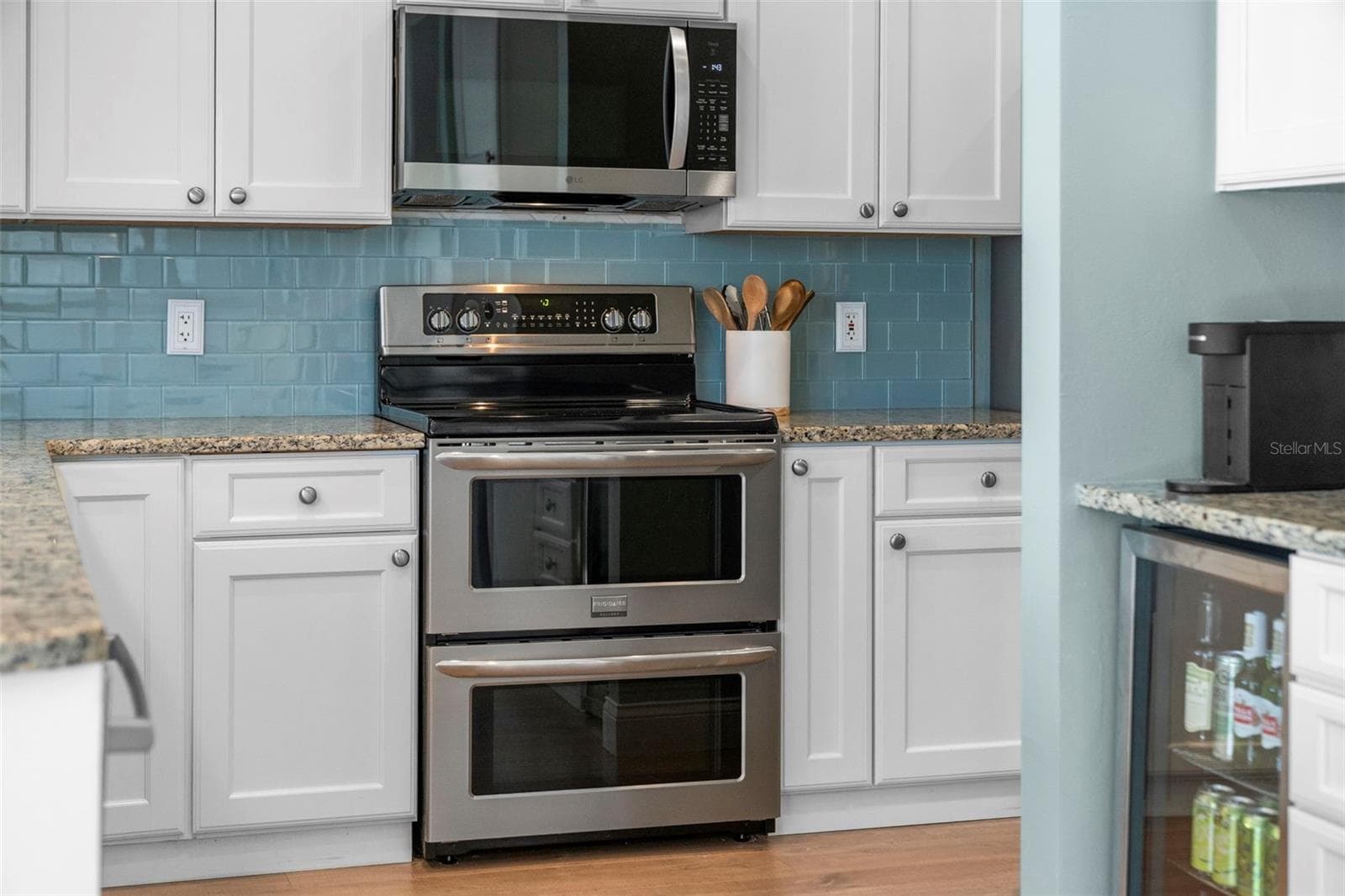 A stainless steel double-oven range offers welcome flexibility for everyday cooking and holiday gatherings. - 4739 COMPASS DR, BRADENTON