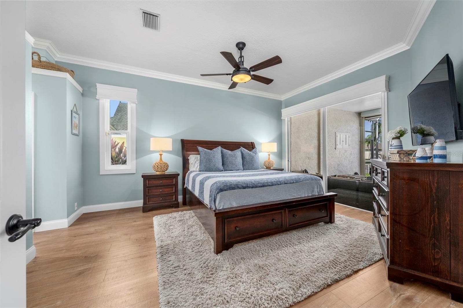 Soft coastal tones and generous natural light create a restful primary retreat with direct access to the lanai. - 4739 COMPASS DR, BRADENTON