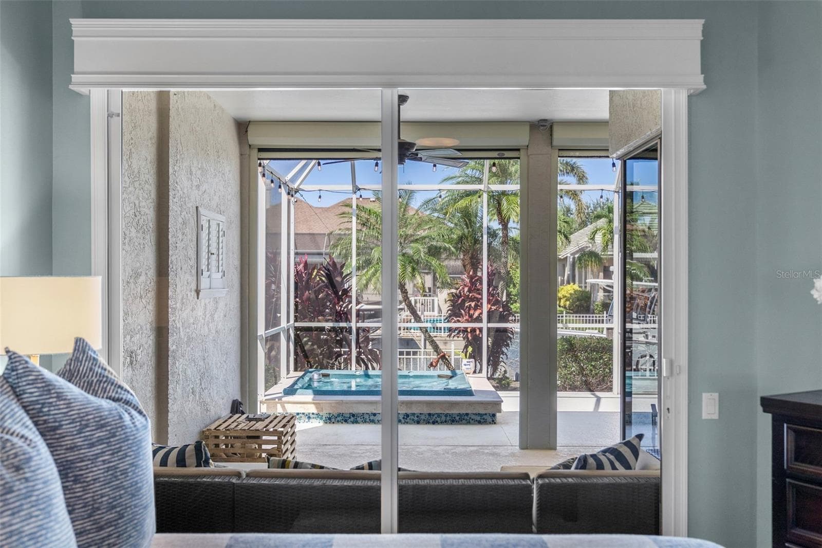 Step outside from your bedroom to enjoy the covered lanai, heated spa, and tropical surroundings. - 4739 COMPASS DR, BRADENTON
