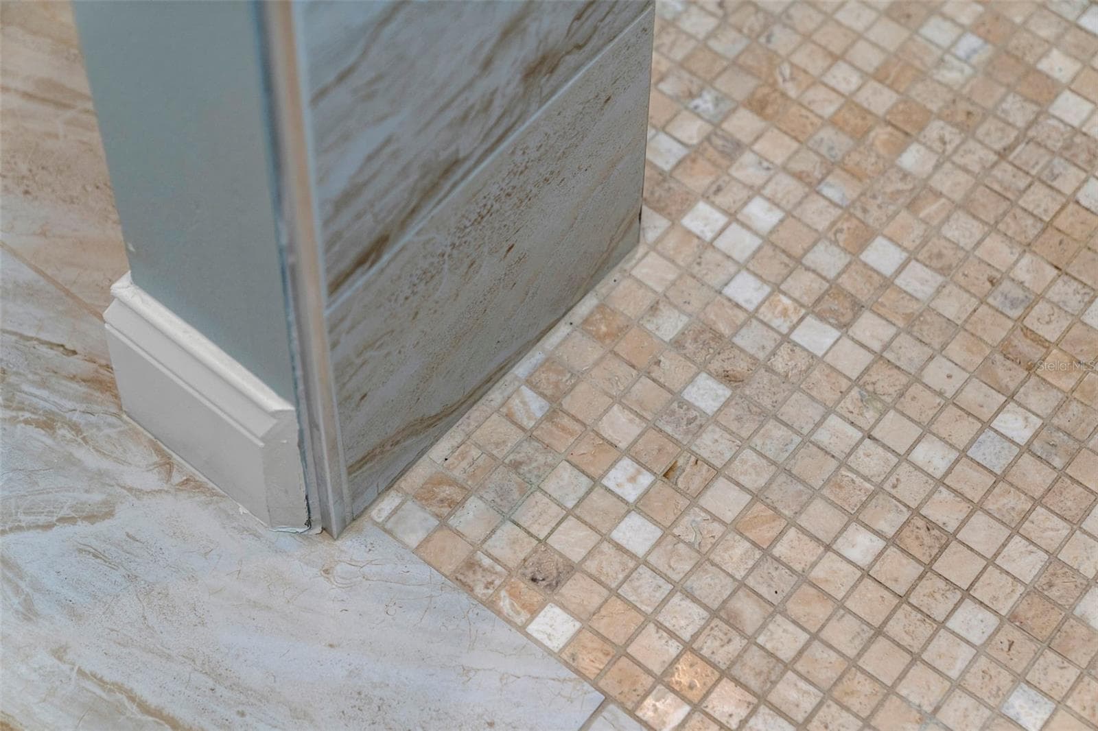 Coordinating mosaic and large-format tile showcase the attention to detail carried throughout the renovation. - 4739 COMPASS DR, BRADENTON