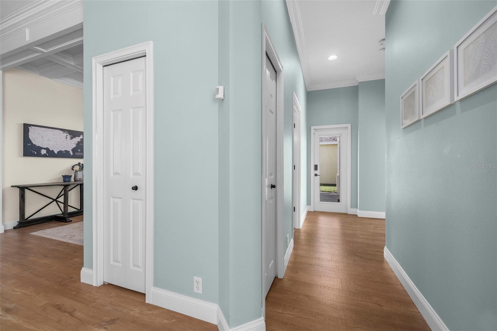Consistent coastal colors, crown molding, and warm flooring create a cohesive feel from room to room. - 4739 COMPASS DR, BRADENTON