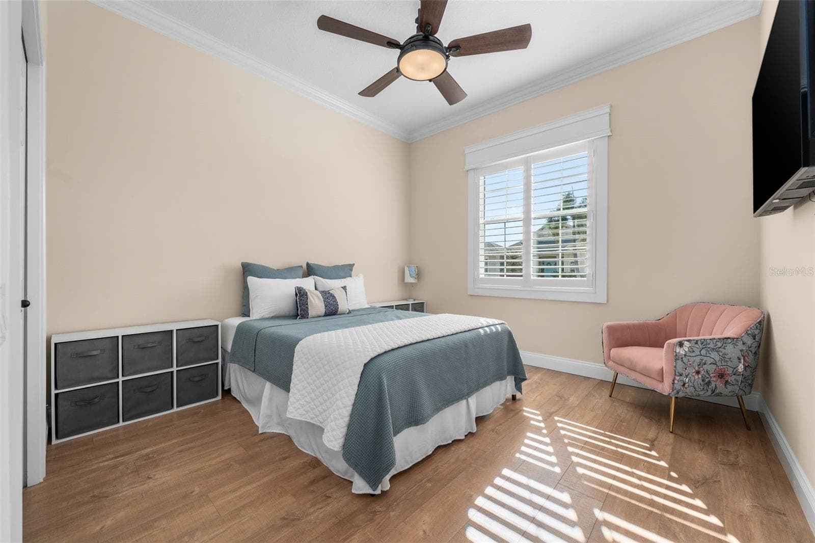 Sunlight filters through plantation shutters, creating a warm and inviting place for guests to unwind. - 4739 COMPASS DR, BRADENTON