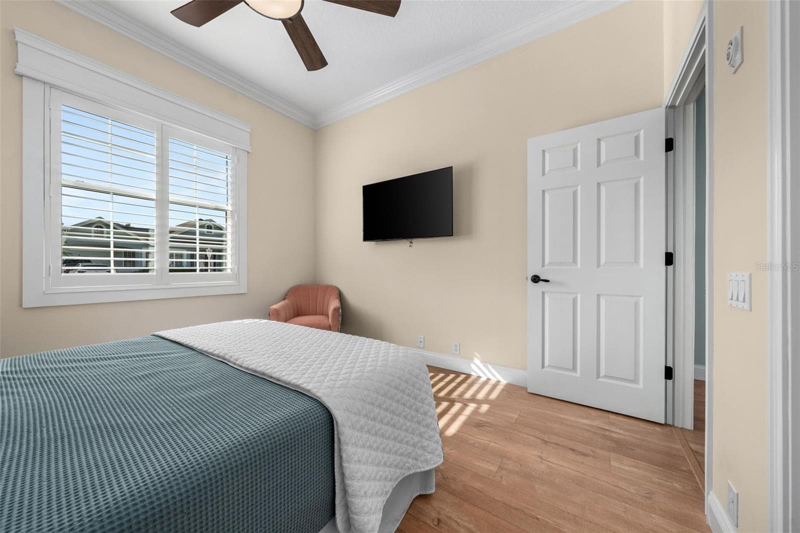 Soft neutral colors, crown molding, and warm flooring make this bedroom easy to personalize. - 4739 COMPASS DR, BRADENTON