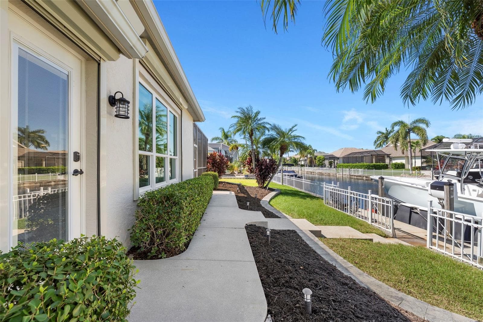 Palm-lined freshwater canals create a beautiful setting, with boating access through the community lift system toward the Manatee River and beyond. - 4739 COMPASS DR, BRADENTON