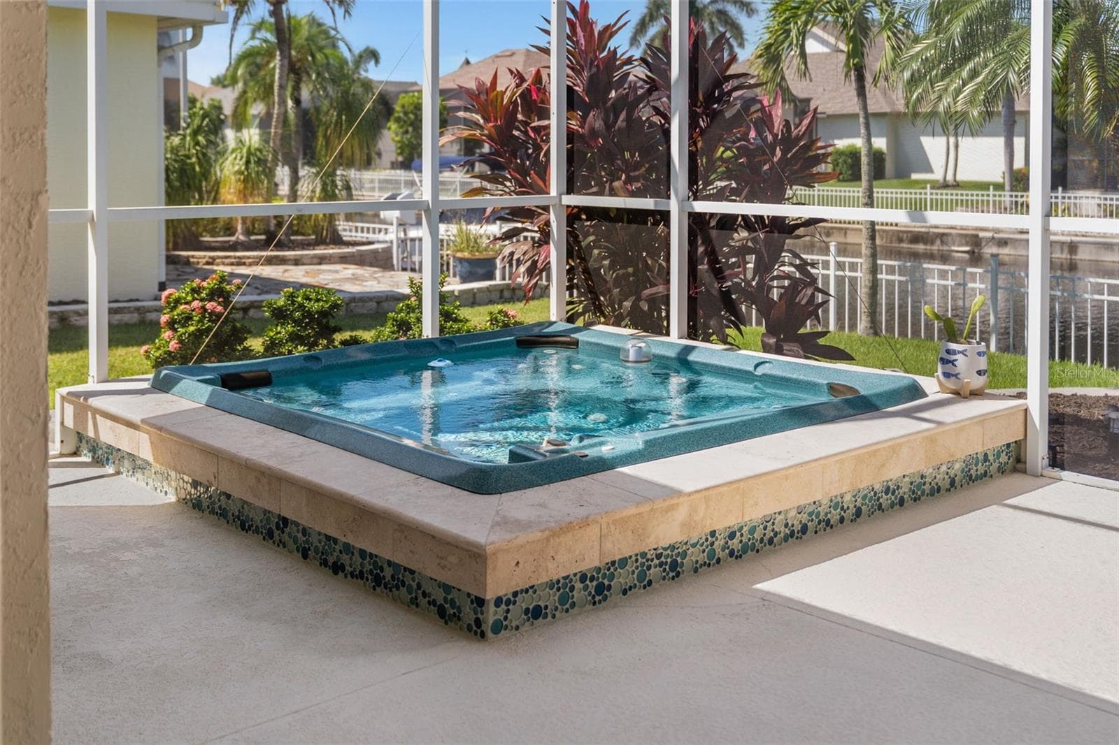 Unwind in your heated spa, surrounded by tropical greenery and peaceful canal views. - 4739 COMPASS DR, BRADENTON
