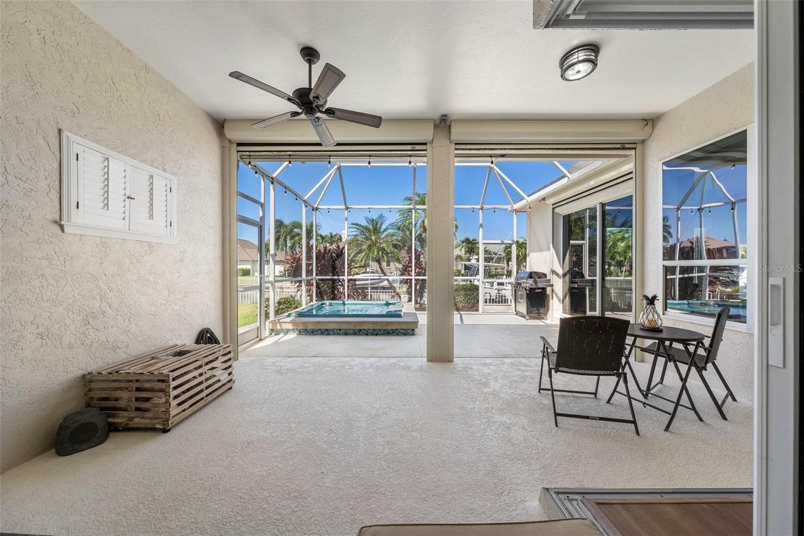A spacious covered lanai offers an inviting spot for morning coffee, casual meals, and relaxing after a day on the water. - 4739 COMPASS DR, BRADENTON