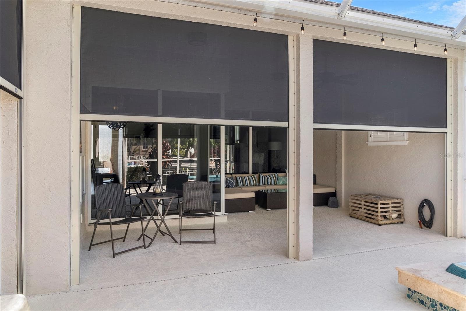 Automatic Kevlar storm shades add protection and everyday shade to the covered outdoor living area. - 4739 COMPASS DR, BRADENTON