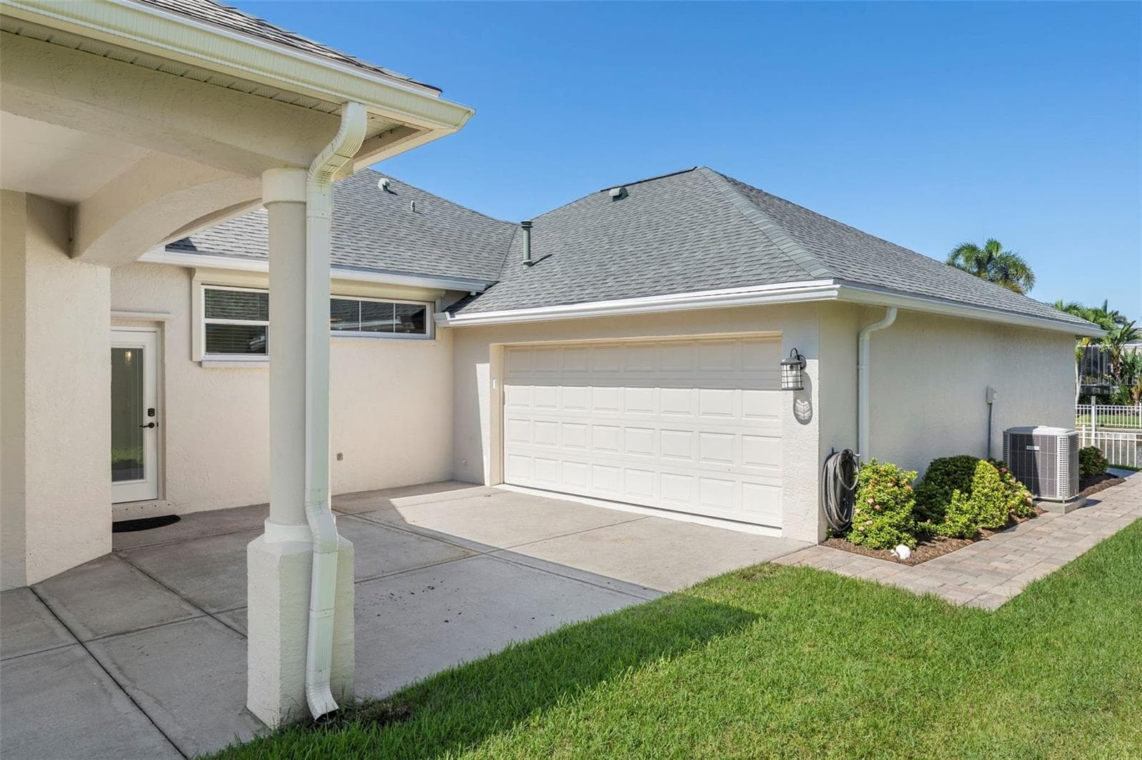 The spacious tandem garage features finished flooring and room for vehicles, a golf cart, storage, and boating essentials. - 4739 COMPASS DR, BRADENTON