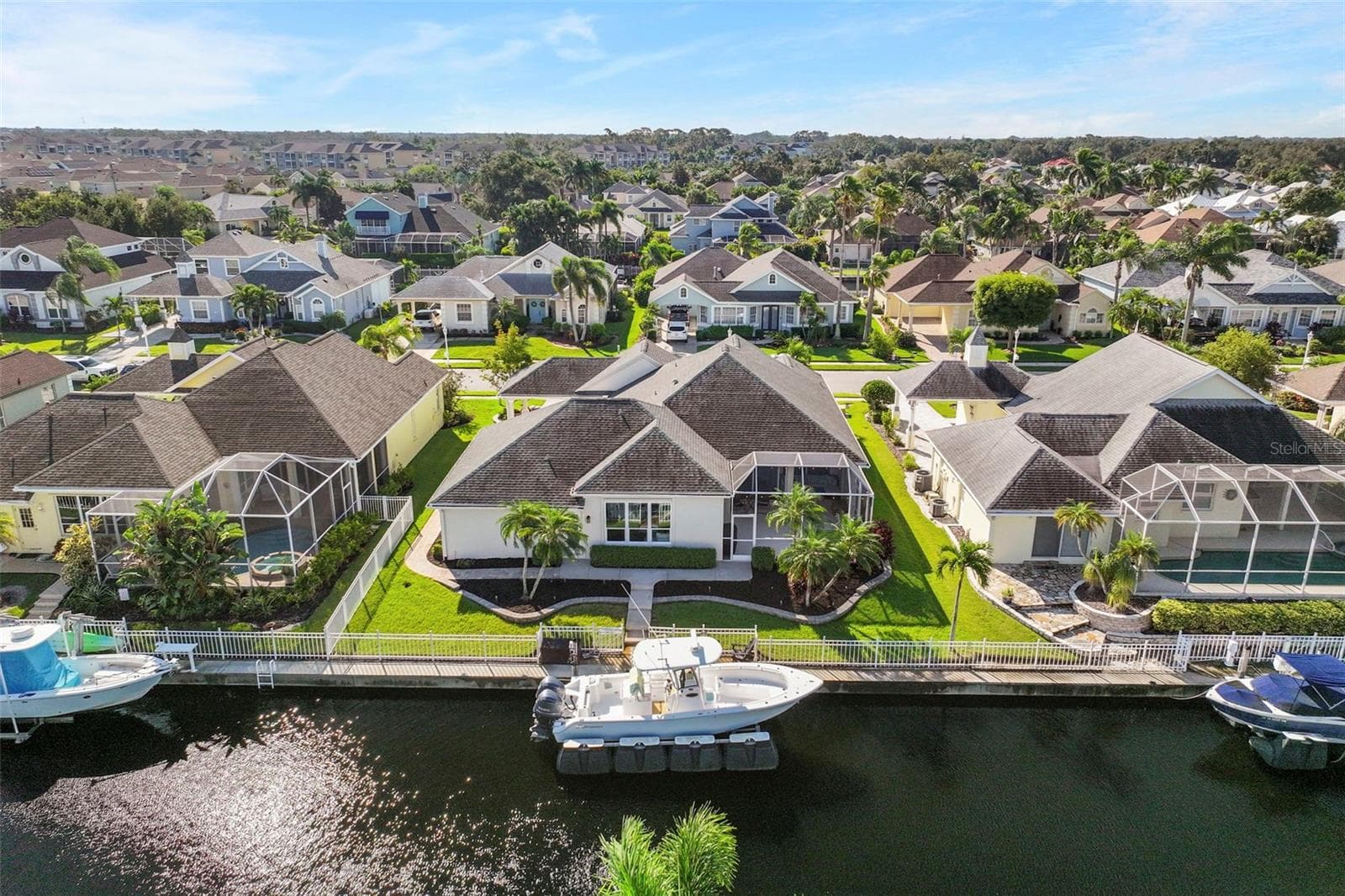 With 75 feet of waterfront, tropical landscaping, and a private dock, outdoor living is part of every day. - 4739 COMPASS DR, BRADENTON