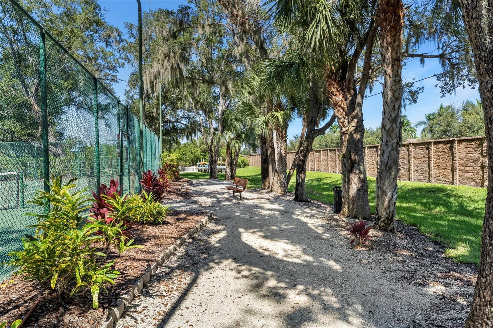 Tree-lined community paths offer a lovely setting for a morning stroll or a quiet afternoon outdoors. - 4739 COMPASS DR, BRADENTON