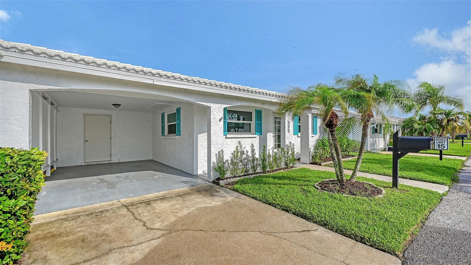 The villa with the carport and storage room. - 693 SPANISH DR N #24, LONGBOAT KEY