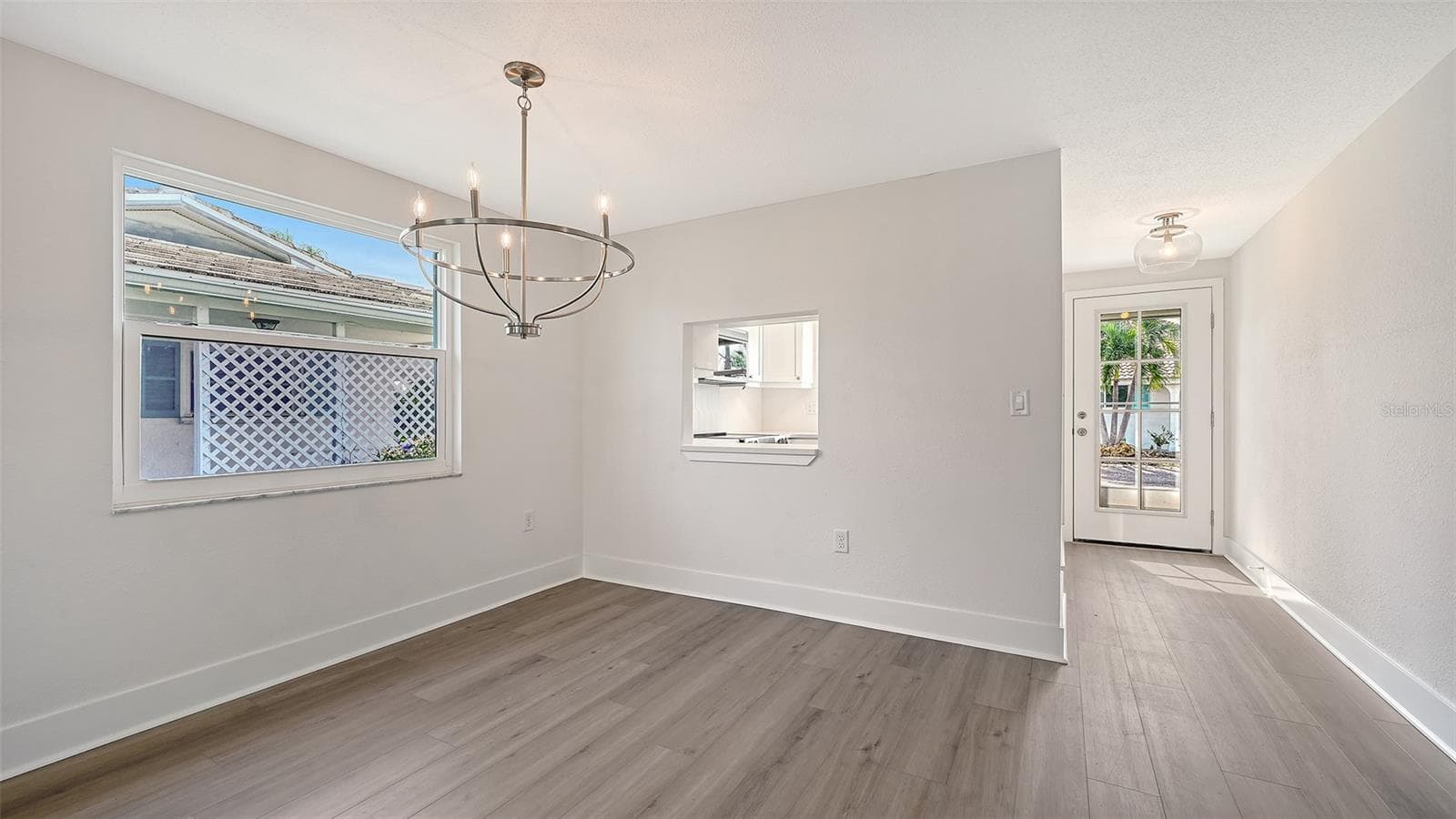 The entry door, Kitchen on the left, Dining Room. - 693 SPANISH DR N #24, LONGBOAT KEY
