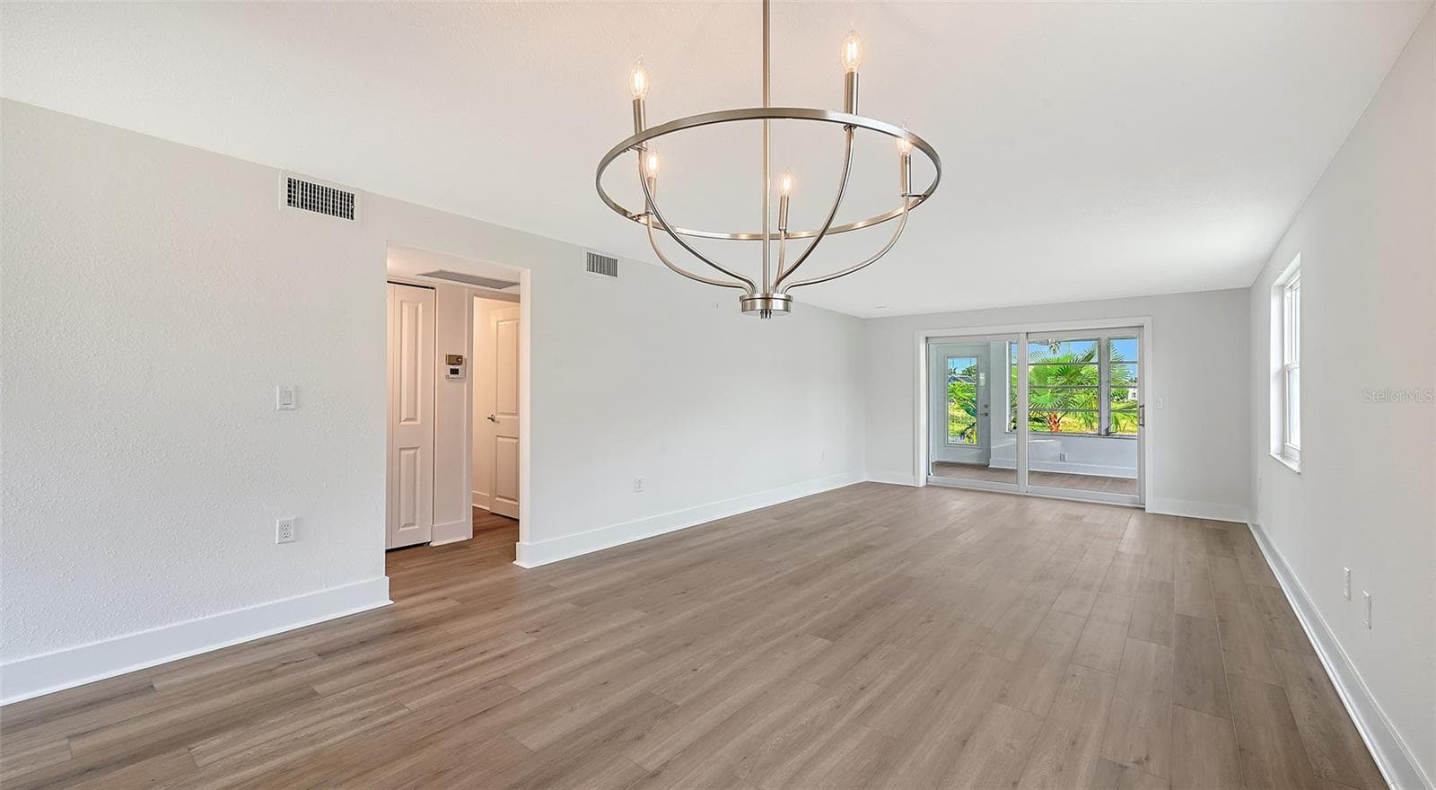 Dining Room/Living Room combination. Hallway to bedrooms. - 693 SPANISH DR N #24, LONGBOAT KEY