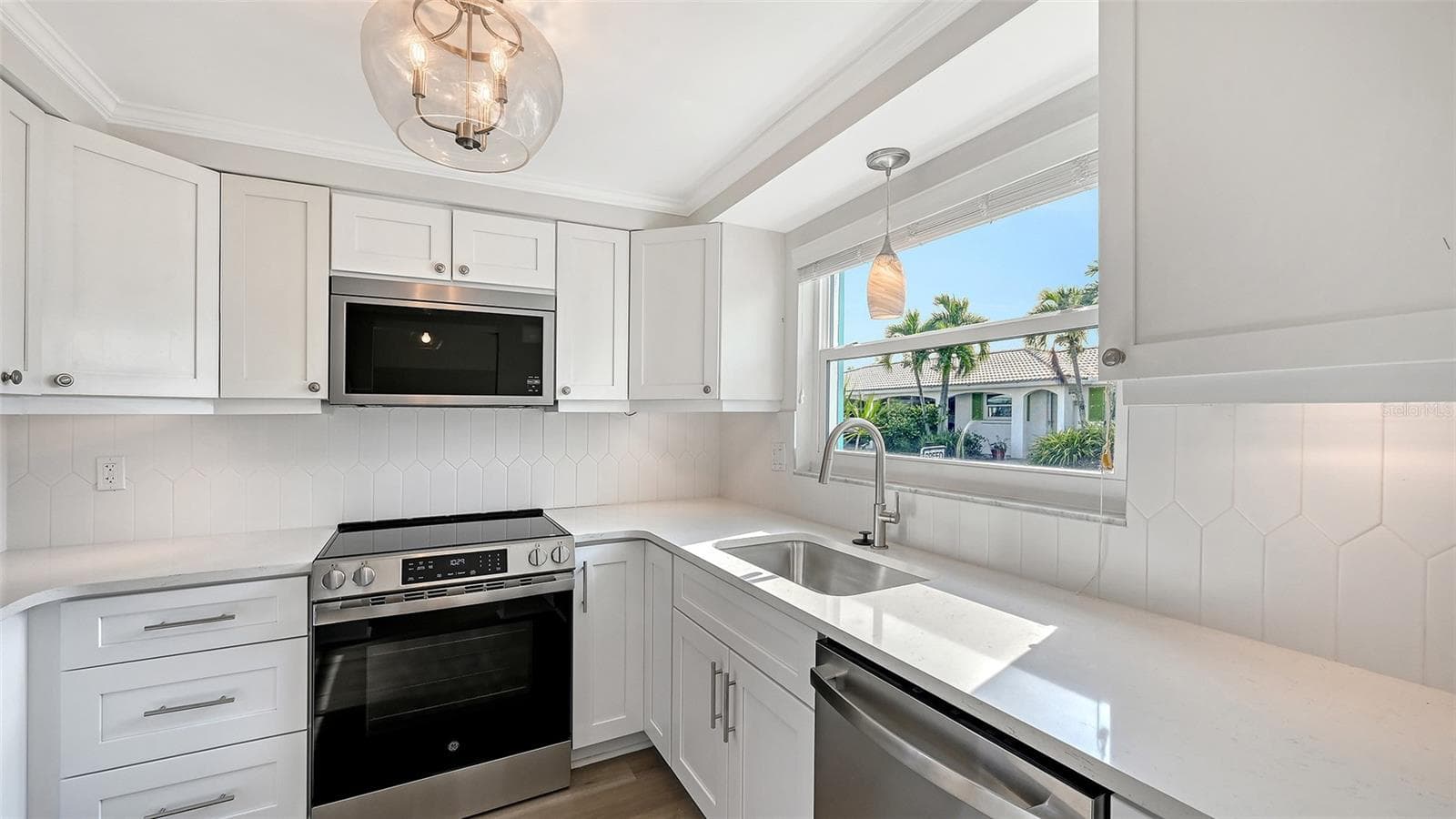 New Kitchen with stone countertops and stainless steel appliances. - 693 SPANISH DR N #24, LONGBOAT KEY