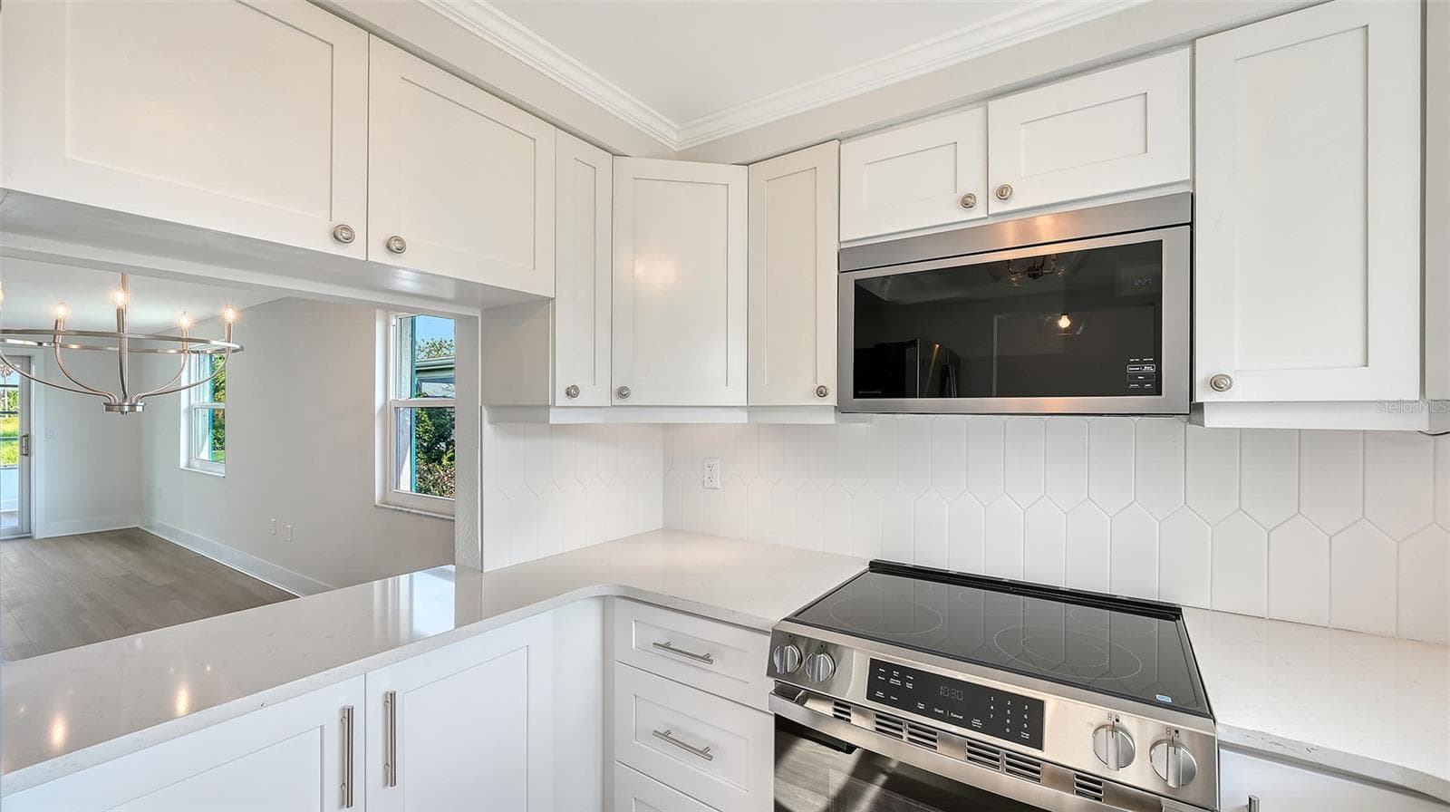 New Kitchen with stone countertops and stainless steel appliances. Pass through to Dining Room. - 693 SPANISH DR N #24, LONGBOAT KEY