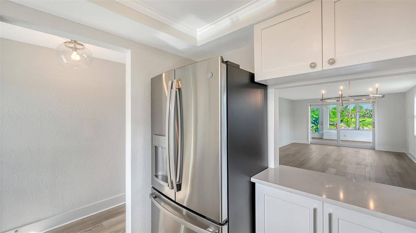 New Kitchen with stone countertops and stainless steel appliances. Pass through to Dining Room. - 693 SPANISH DR N #24, LONGBOAT KEY