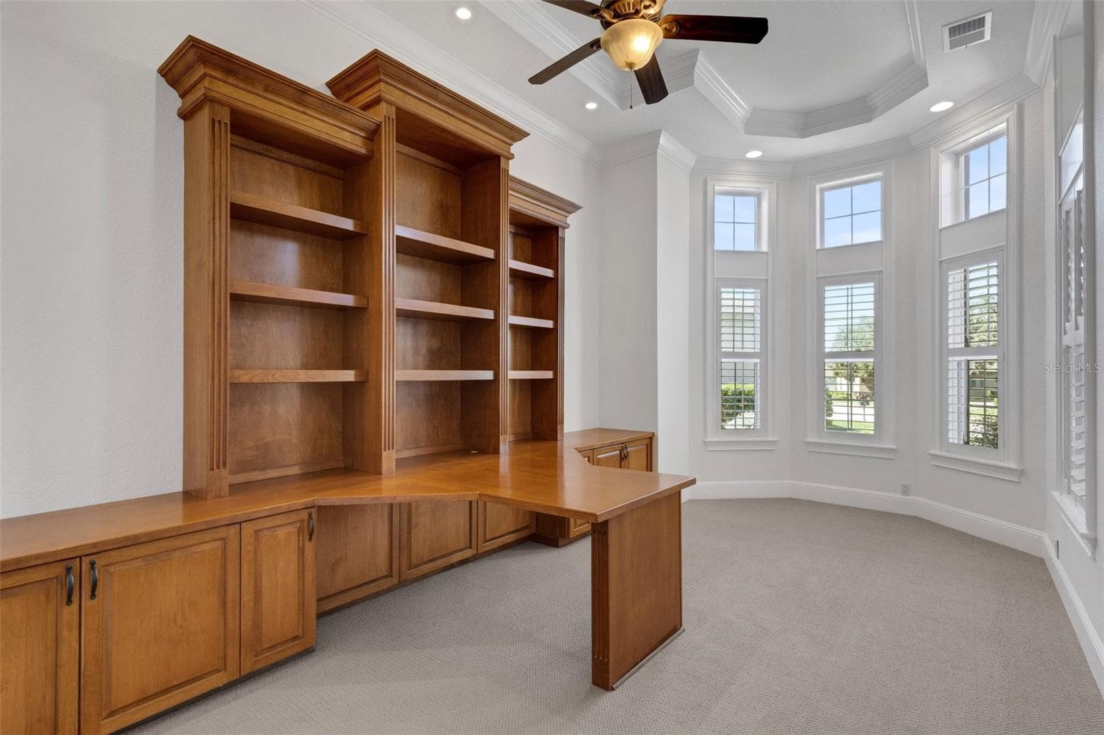 The office has a massive built-in two-person desk and shelf system. - 6562 EAGLE VIEW LOOP, LAKELAND