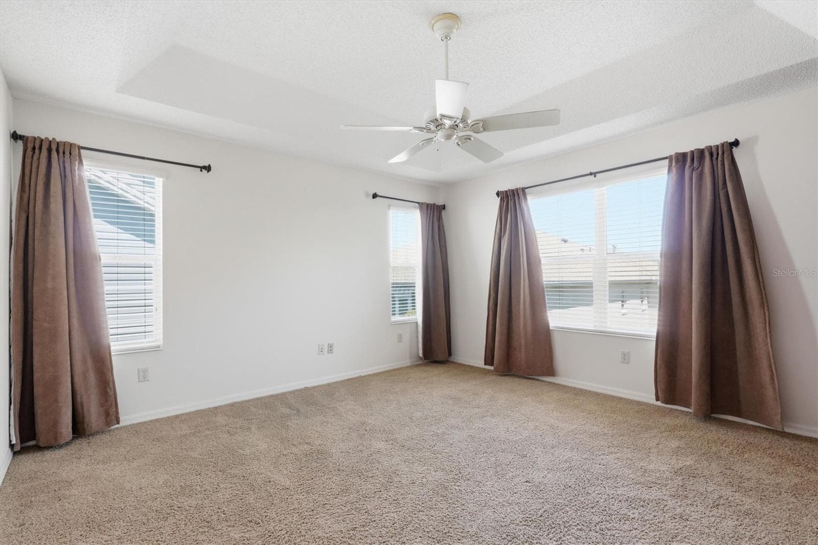 Primary Bedroom with Tray Ceiling, plenty of windows for that added natural light. - 1563 EASTOVER TER, THE VILLAGES