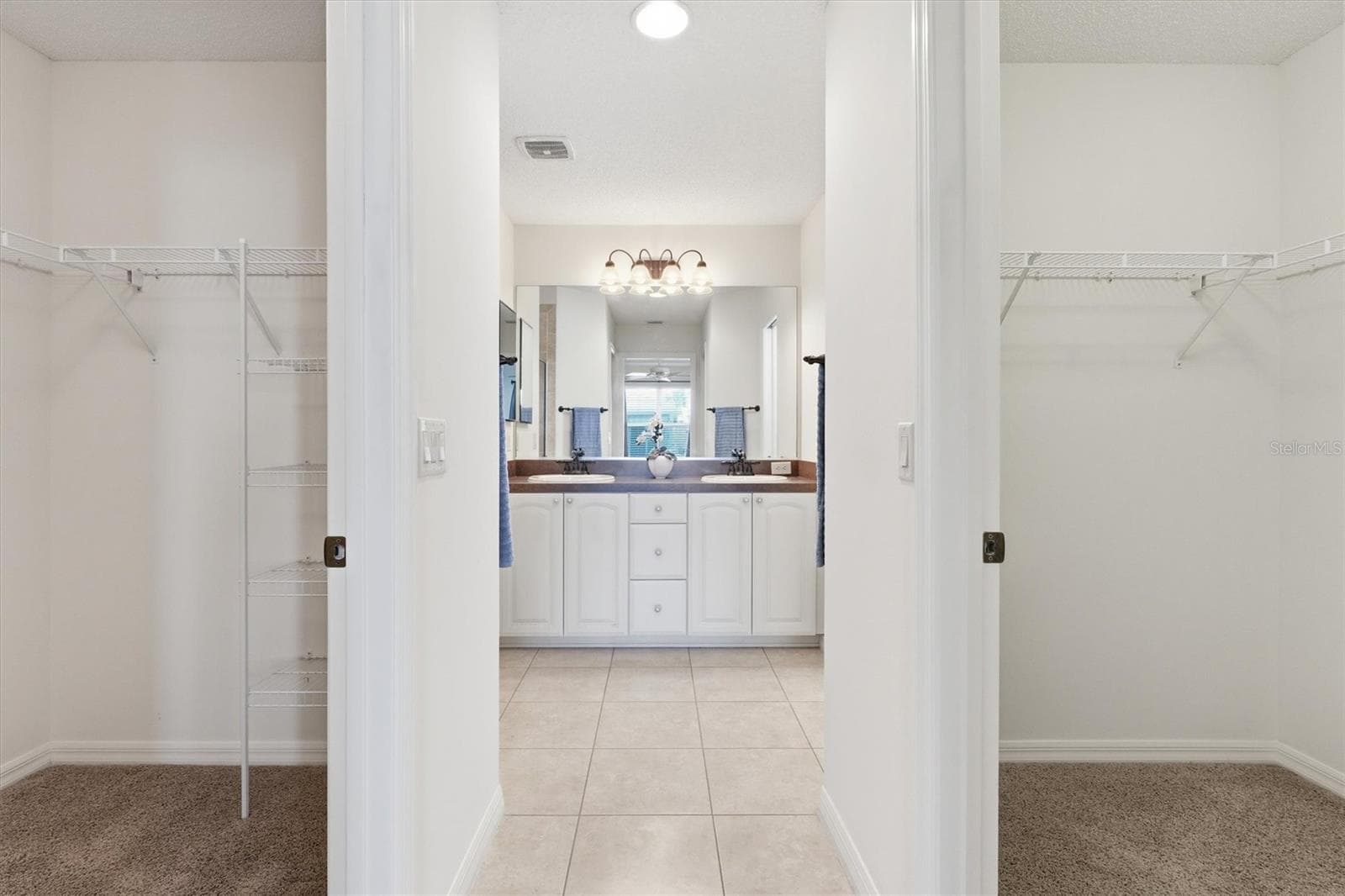 Primary Dual Walk In Closets going into the Primary En-Suite. - 1563 EASTOVER TER, THE VILLAGES