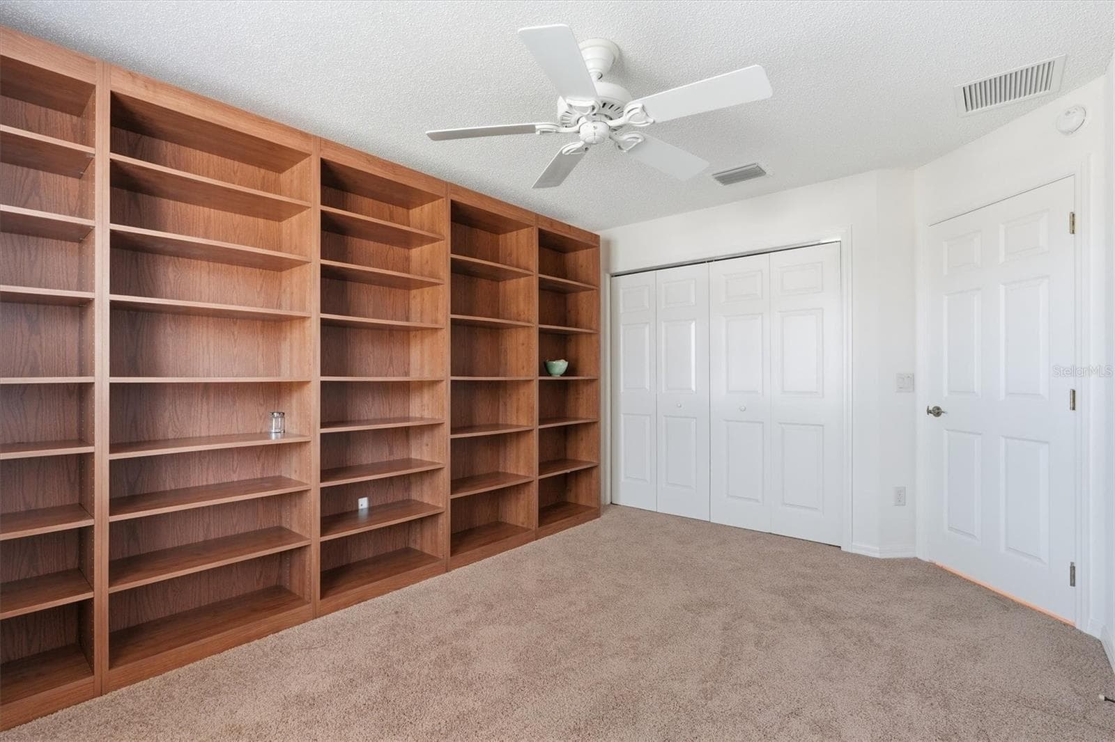 Bedroom #2 has custom bookshelves, perfect for a Office. - 1563 EASTOVER TER, THE VILLAGES