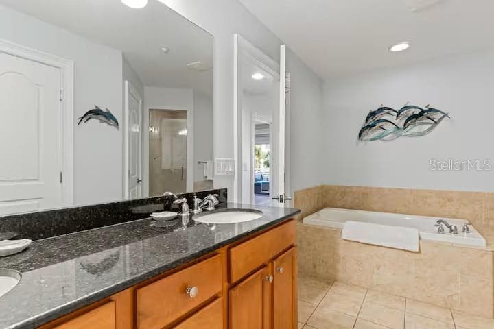 Primary ensiut bathroom with large soaking tub, walk in shower, and private water closet. - 100 BAYSIDE DR #101, CLEARWATER