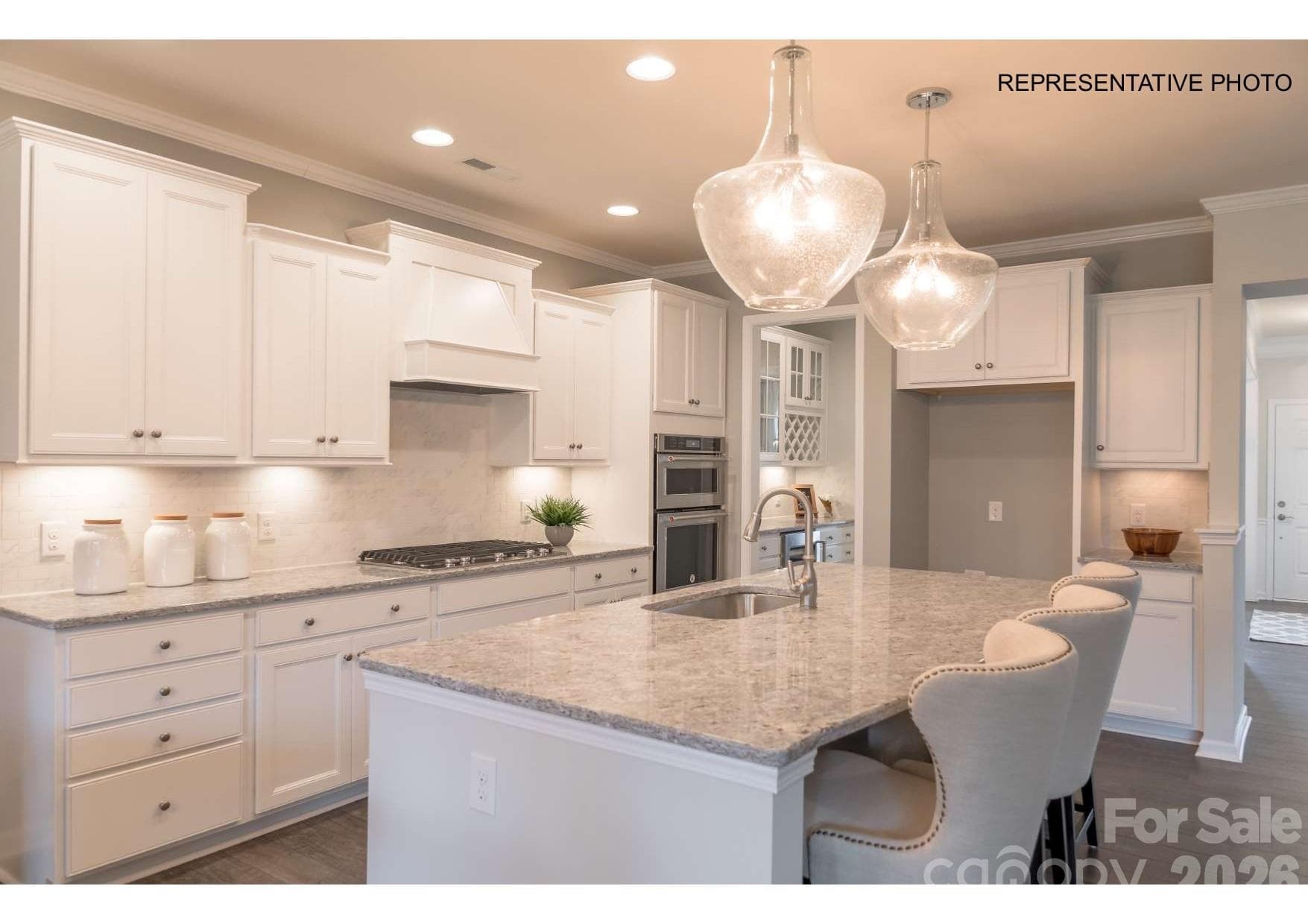 Incredible kitchen with oversized island, ample storage, and designer finishes - 7689 Pedigree Circle, Lancaster