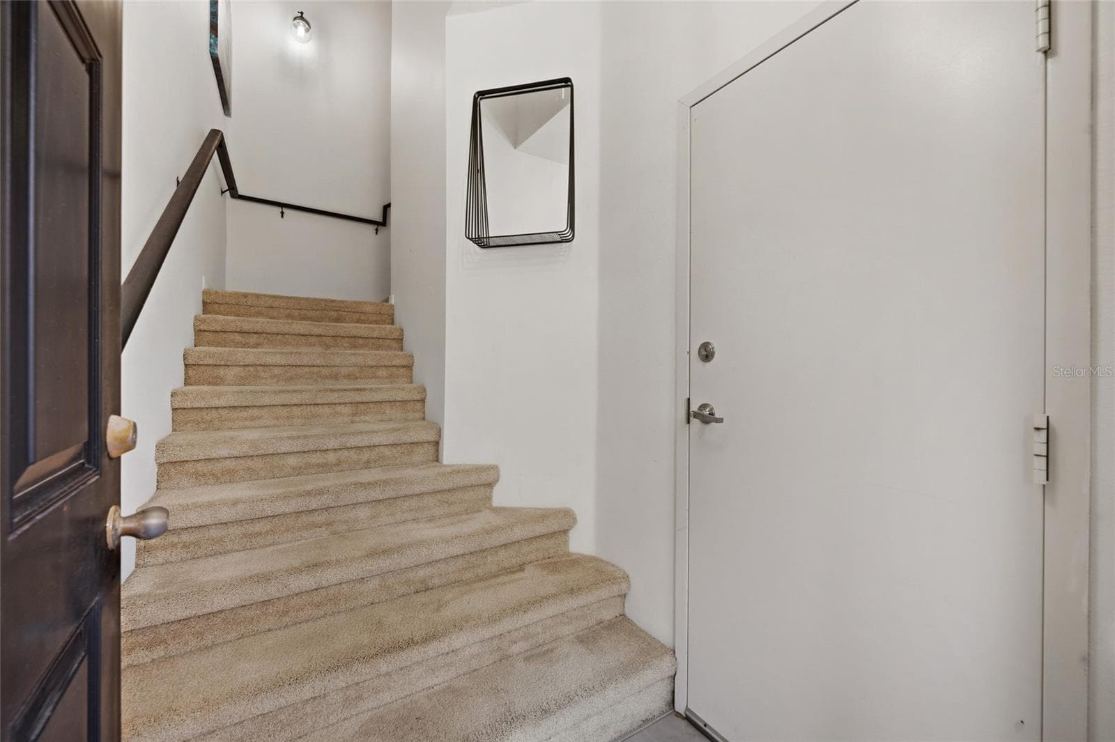 stairs leading up to living area.  Garage door coming into home - 15613 BOGGY OAK CIR #110A, WINTER GARDEN