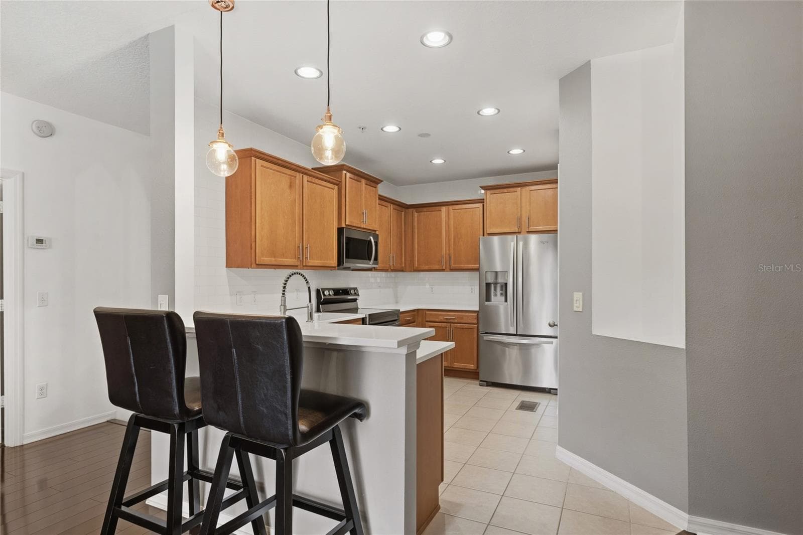 kitchen bar perfect for two to sit and enjoy a meal - 15613 BOGGY OAK CIR #110A, WINTER GARDEN
