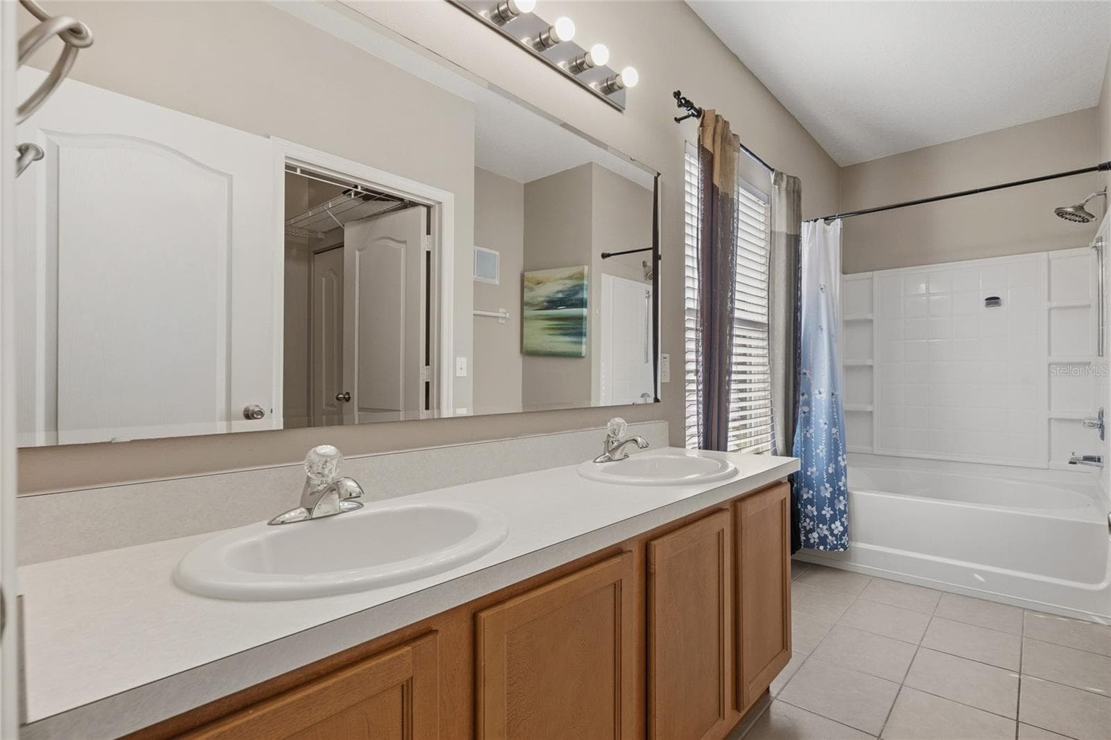 Primary Bathroom with double sinks, tub/shower combo and water closet - 15613 BOGGY OAK CIR #110A, WINTER GARDEN