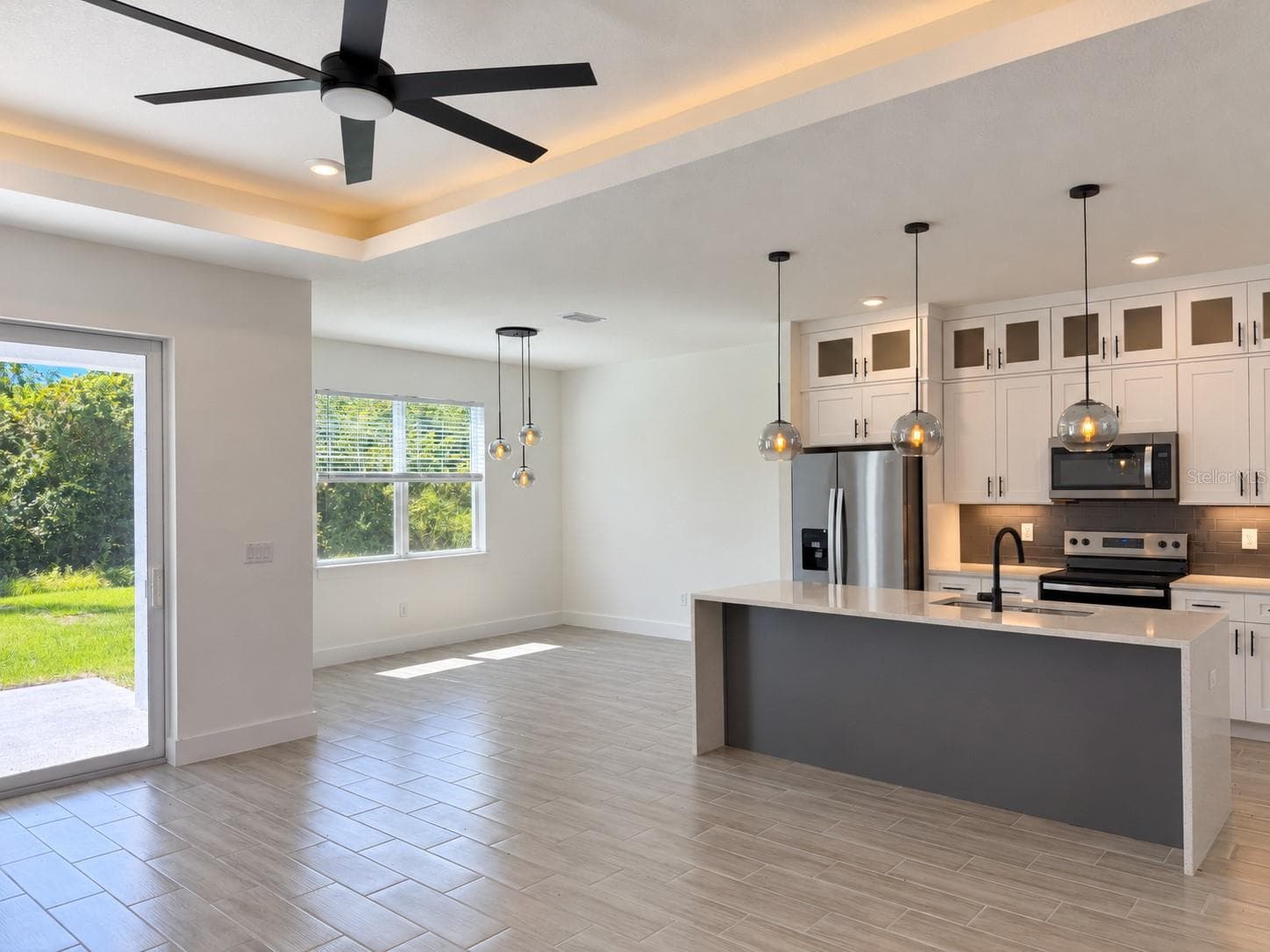 Kitchen and dining connection. Actual property photo, digitally refined. - 24479 SW KINGSWAY CIR, ARCADIA