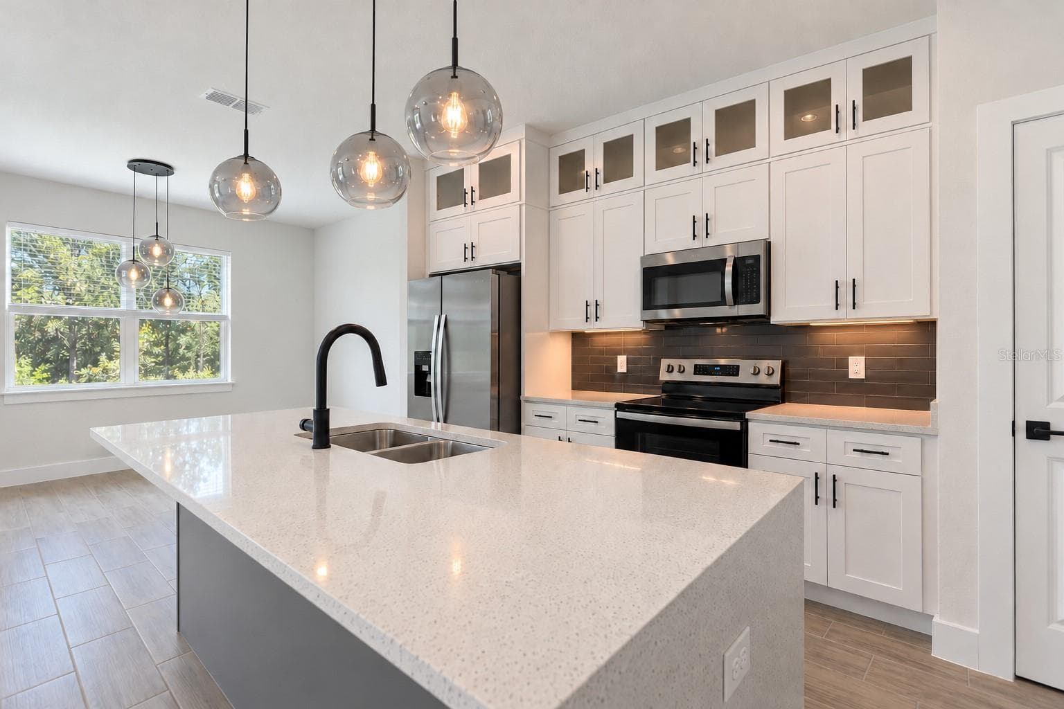 Kitchen sink angle. Digitally edited model/property composite. - 24479 SW KINGSWAY CIR, ARCADIA