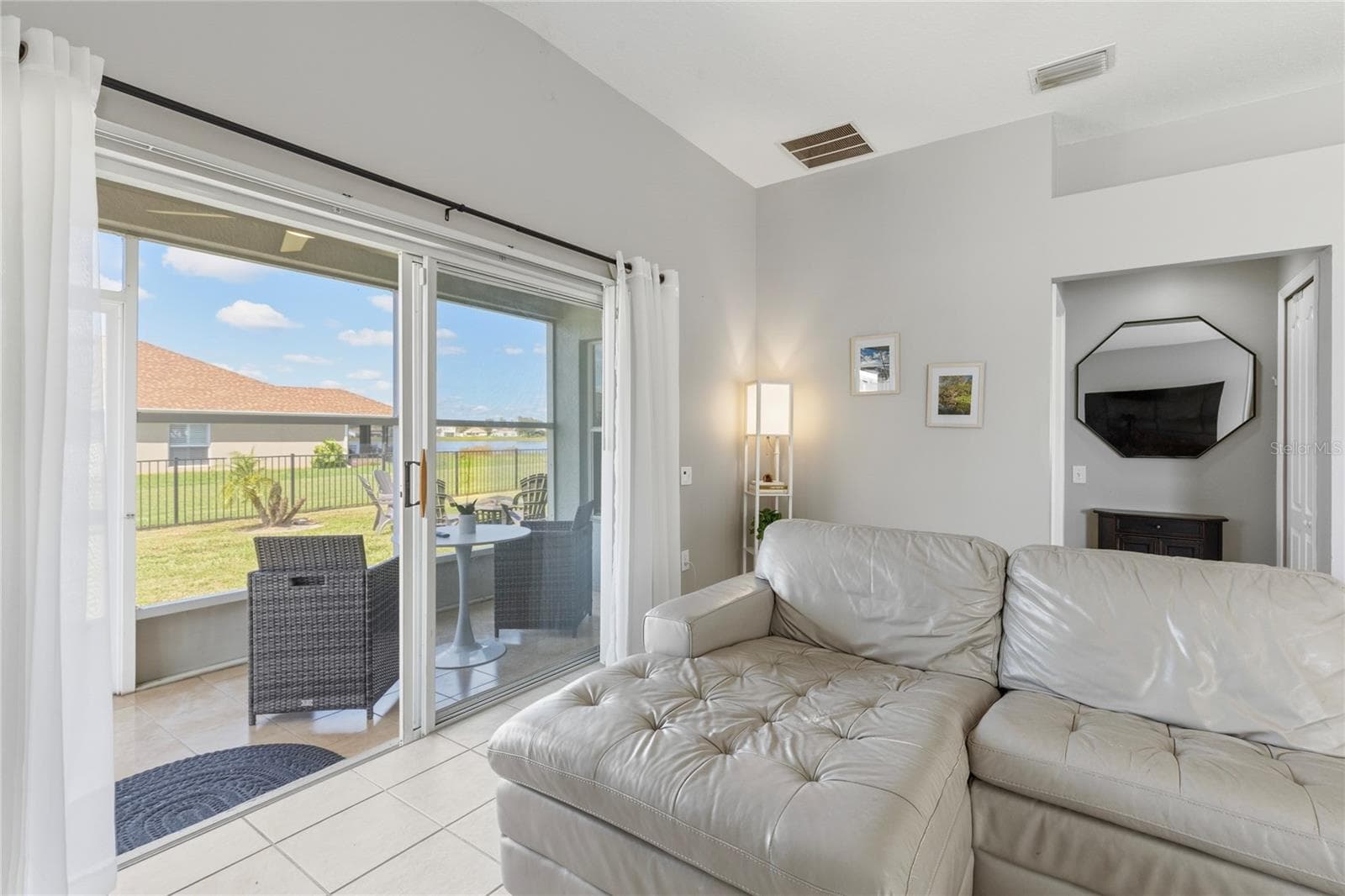 Family room overlooking pond view - 7619 CRESCENT PALM DR, WESLEY CHAPEL