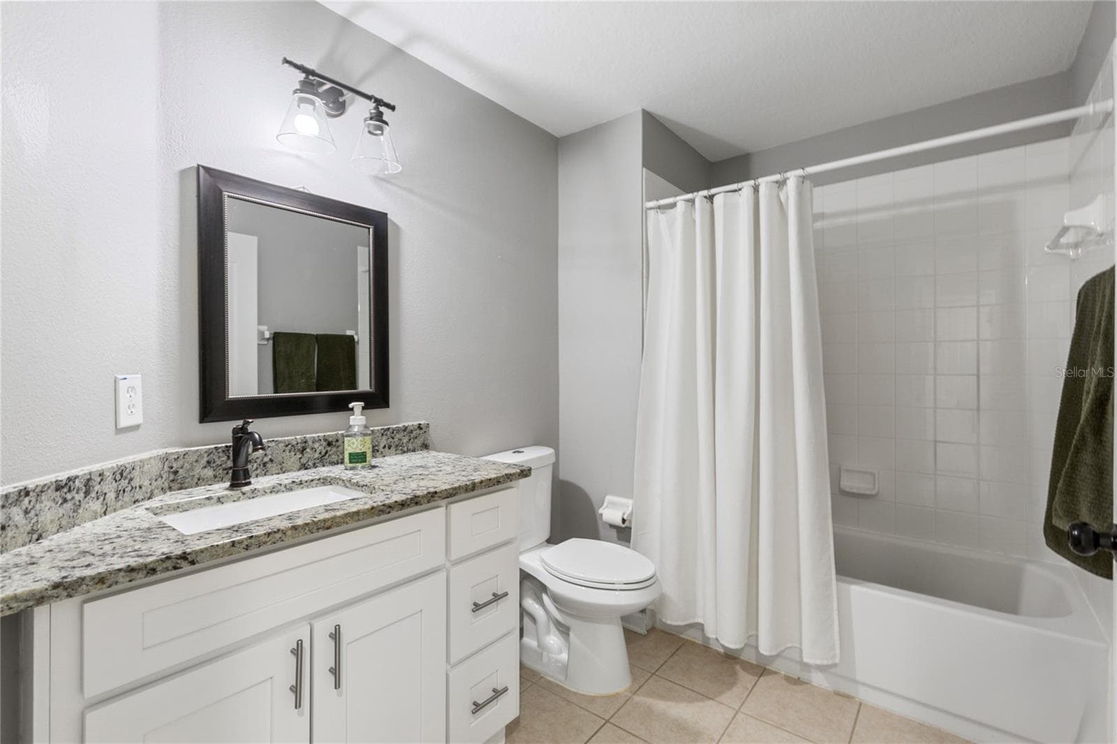 Granite countertop and drawer space in guest baths. - 7619 CRESCENT PALM DR, WESLEY CHAPEL