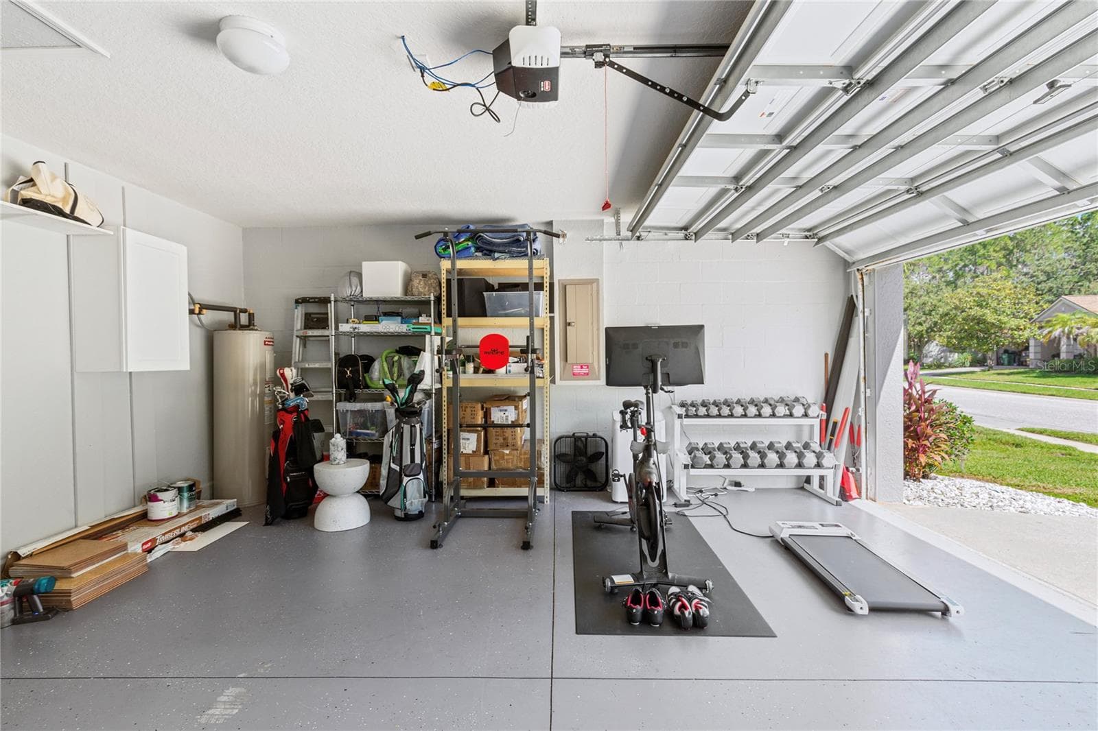 Garage used for parking and a home gym now - 7619 CRESCENT PALM DR, WESLEY CHAPEL