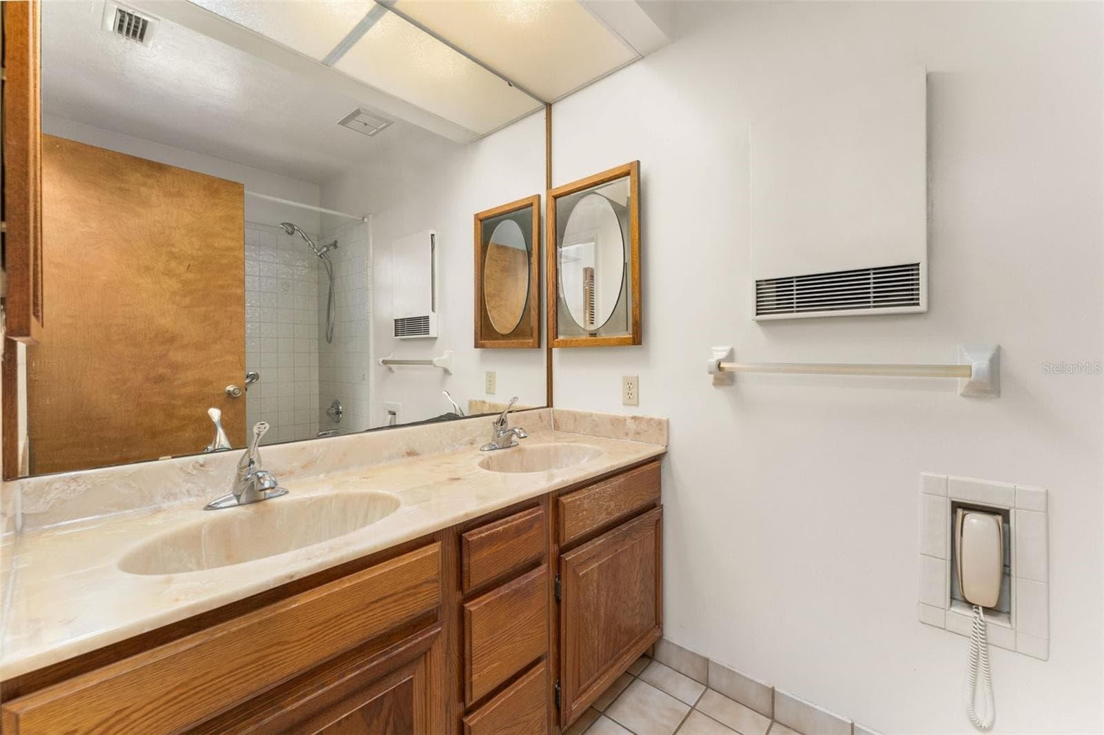 Primary bathroom with dual sinks and tub/shower - 5804 NW 158TH ST, ALACHUA