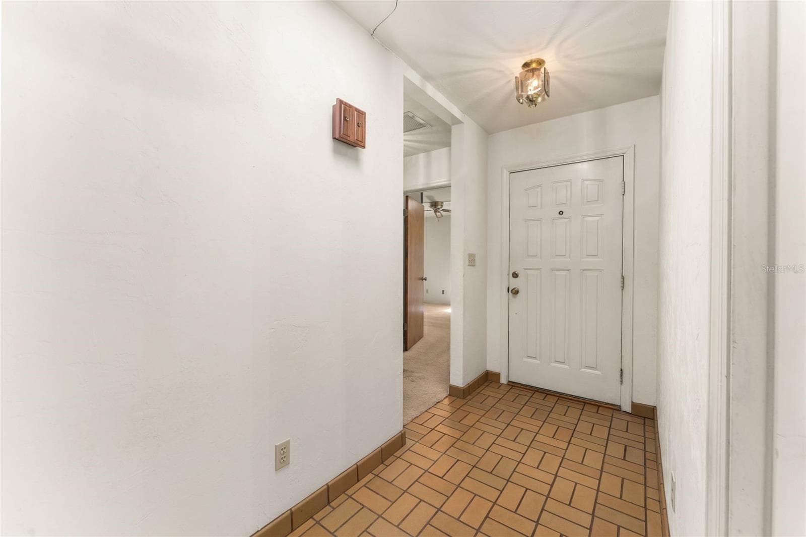 Front door hallway to bedrooms 2 and 3 as well as living room - 5804 NW 158TH ST, ALACHUA