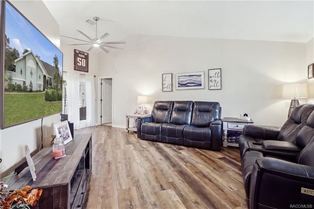 LIVING ROOM – VAULTED CEILING- Spacious living area featuring a vaulted ceiling, newer luxury vinyl flooring & ceiling fan. - 1436 N CHERRY POP DR, HERNANDO
