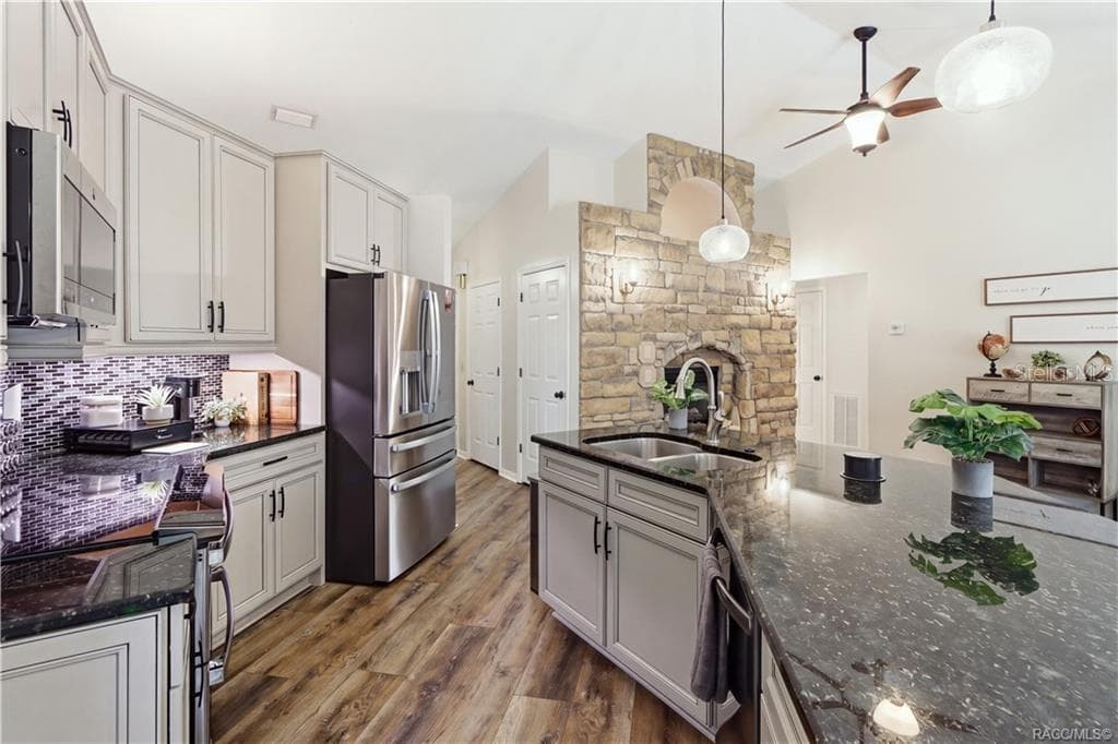 KITCHEN ADDITIONAL VIEW- Beautiful kitchen featuring a large granite island w/double-basin sink, abundant cabinetry, newer appliances & updated flooring. - 1436 N CHERRY POP DR, HERNANDO