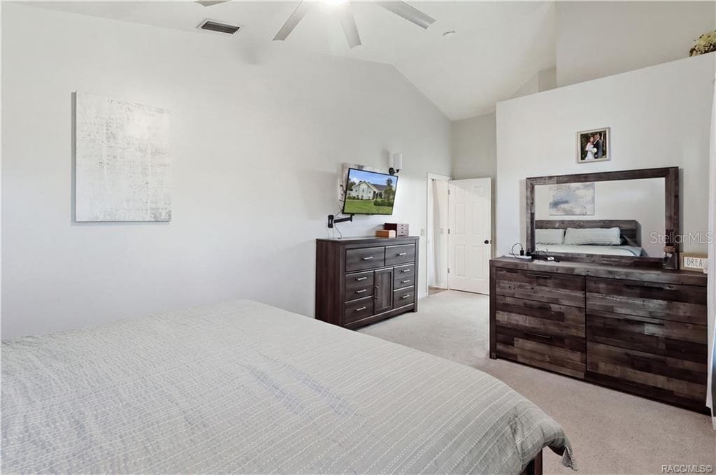 Primary Bedroom – Another view of the primary suite showcasing its vaulted ceiling, spacious layout & comfortable atmosphere w/plant shelving for your collectibles. - 1436 N CHERRY POP DR, HERNANDO