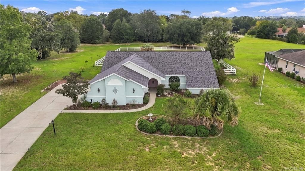 Aerial Front View – Elevated perspective showcasing the home's attractive roofline, landscaping & generous homesite. - 1436 N CHERRY POP DR, HERNANDO