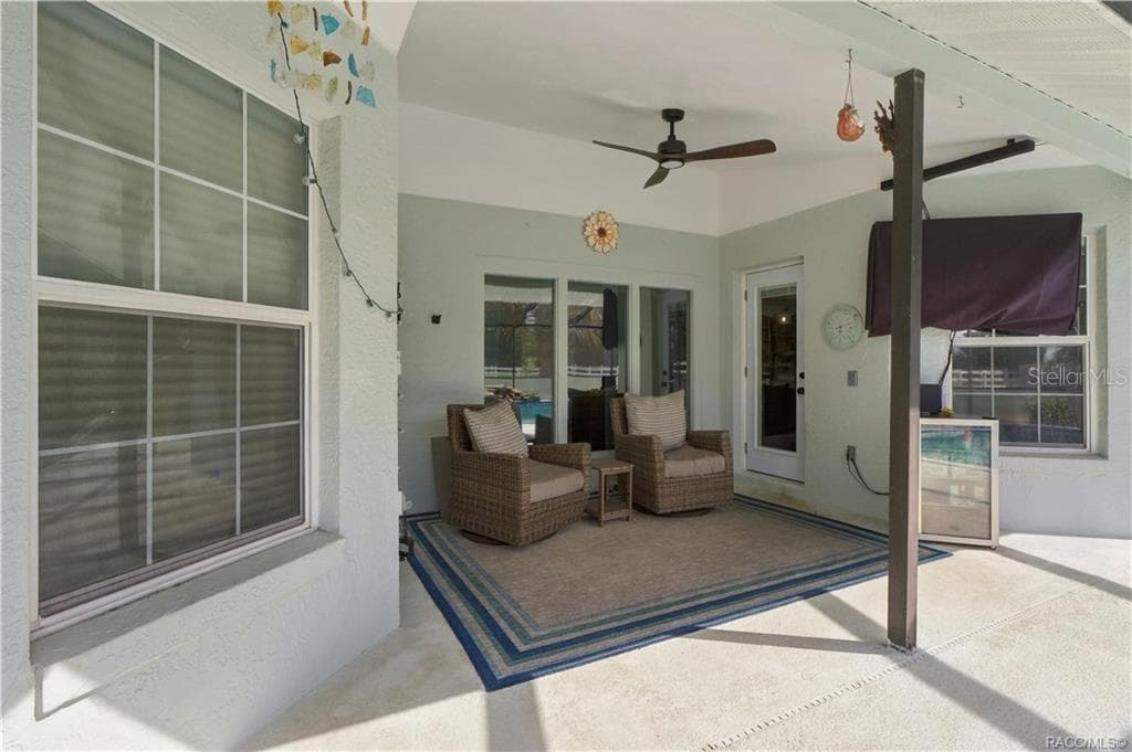 Covered Poolside Seating – Relax in the shaded seating area overlooking the pool, perfect for morning coffee or unwinding outdoors. - 1436 N CHERRY POP DR, HERNANDO