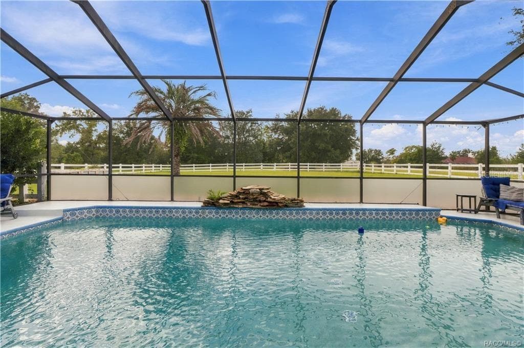 Screen-Enclosed Pool – Enjoy the ELECTRIC-HEATED CHLORINE POOL featuring a decorative waterfall & views of the spacious backyard. - 1436 N CHERRY POP DR, HERNANDO