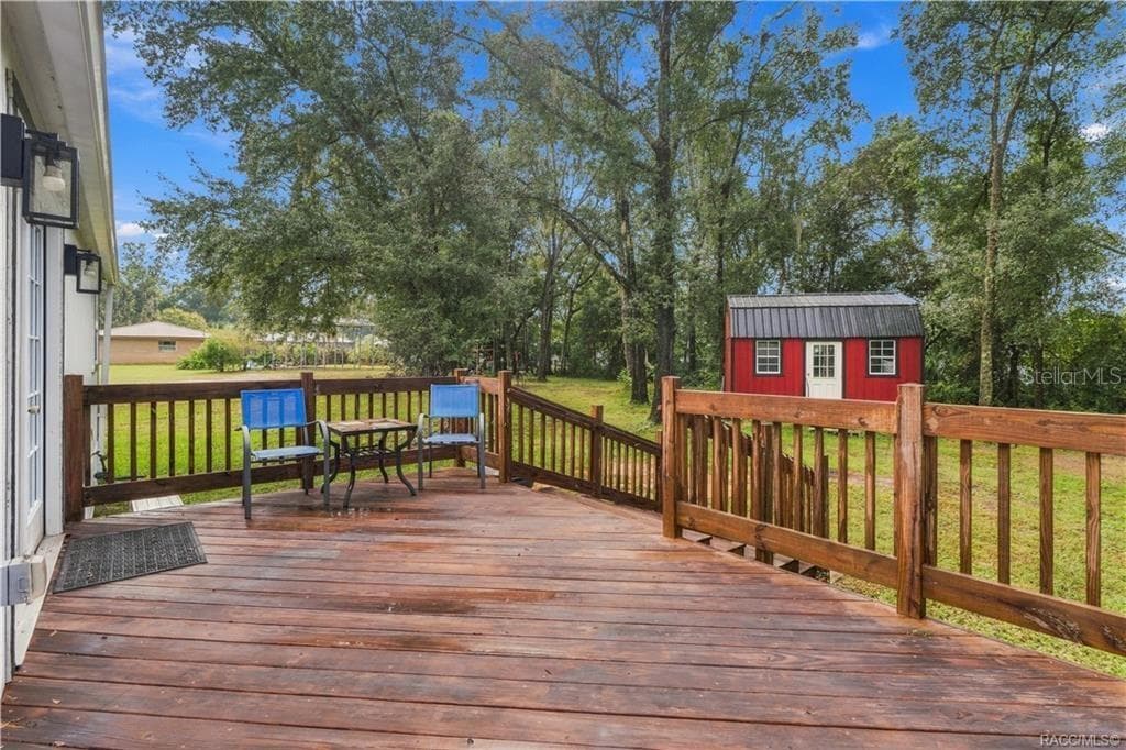 Rear Deck – Step outside & enjoy the spacious WOODEN REAR DECK overlooking the backyard! A wonderful spot for morning coffee, outdoor conversation or relaxing beneath the surrounding trees. - 6230 W GLEN ROBBIN CT, CRYSTAL RIVER