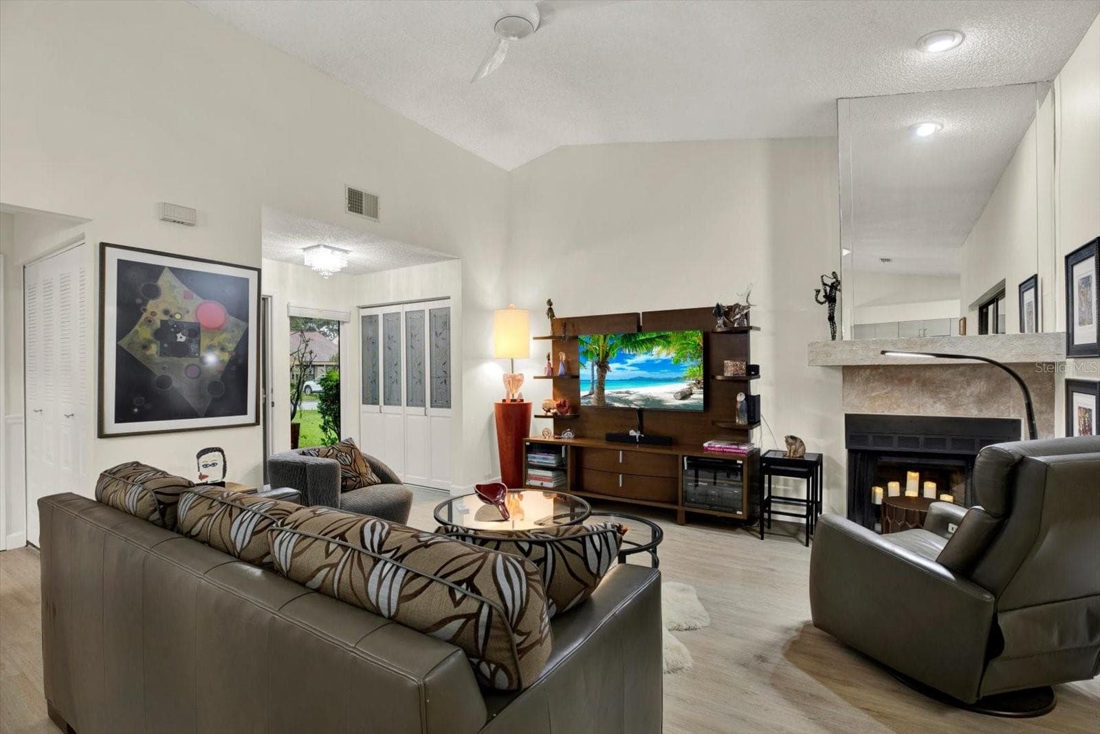 Main living area feacture a fireplace on the corner - 3433 HILLMOOR DR, PALM HARBOR