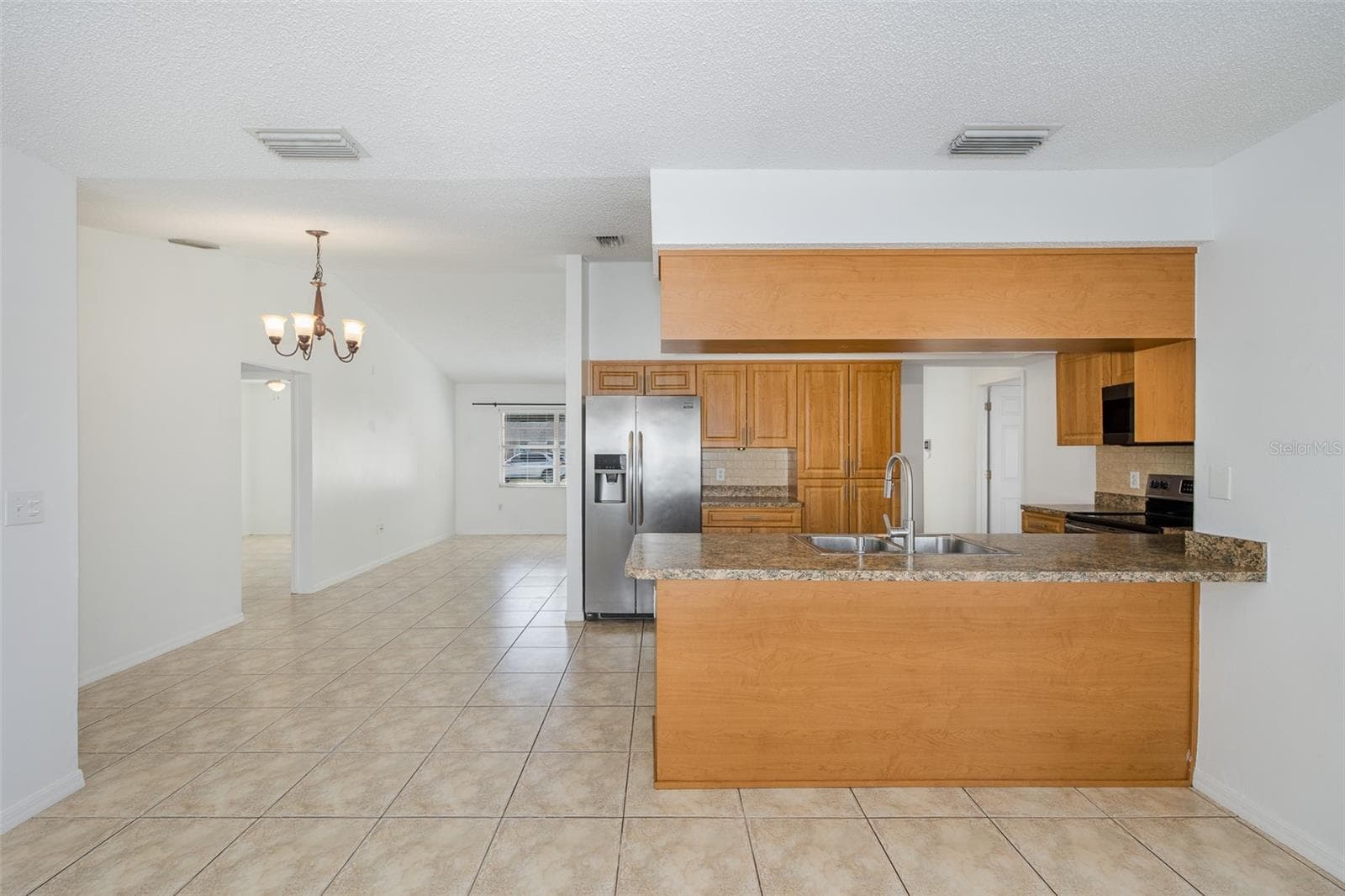 Kitchen and dining room from the family room - 8231 MATTHEW DR, NEW PORT RICHEY