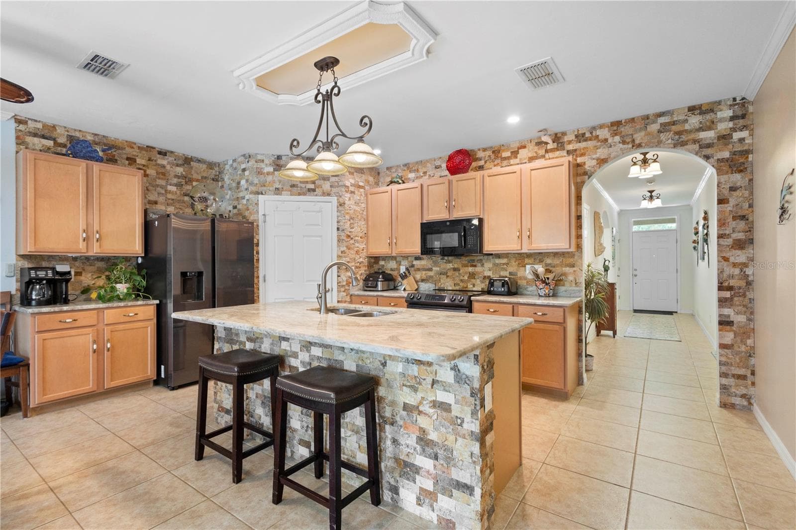 Beautiful brick accents adorn kitchen, bricks attached one by one. - 9259 CALUMET BLVD, PORT CHARLOTTE
