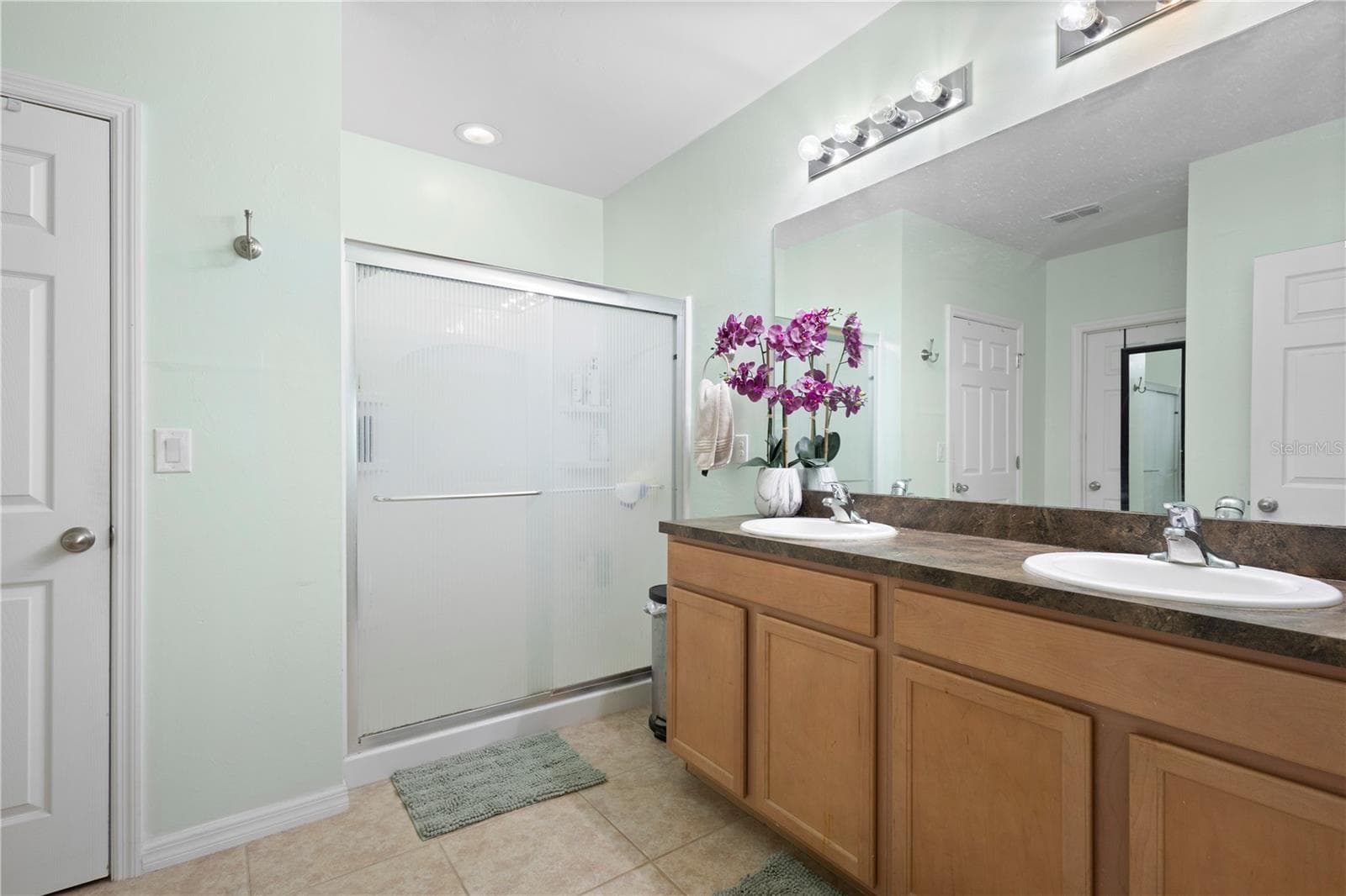 Primary bath with walk-in shower, dual sinks and large walk-in closet. - 9259 CALUMET BLVD, PORT CHARLOTTE