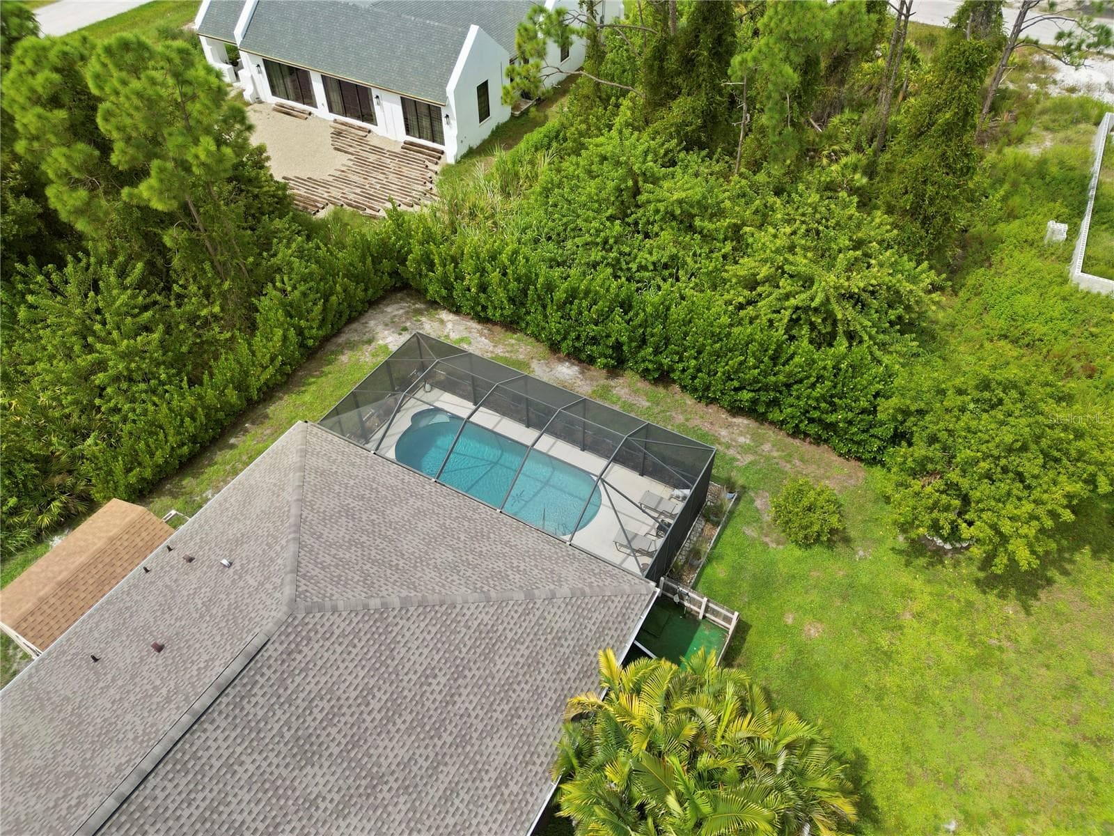 Drone view of home, currently vacant lot behind the property. - 9259 CALUMET BLVD, PORT CHARLOTTE
