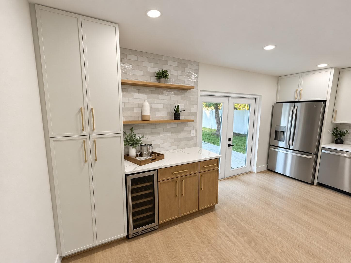Cabinet pantry, beverage cooler, floating shelves and French doors out to pool - 1613 GREENWOOD DR, DUNEDIN